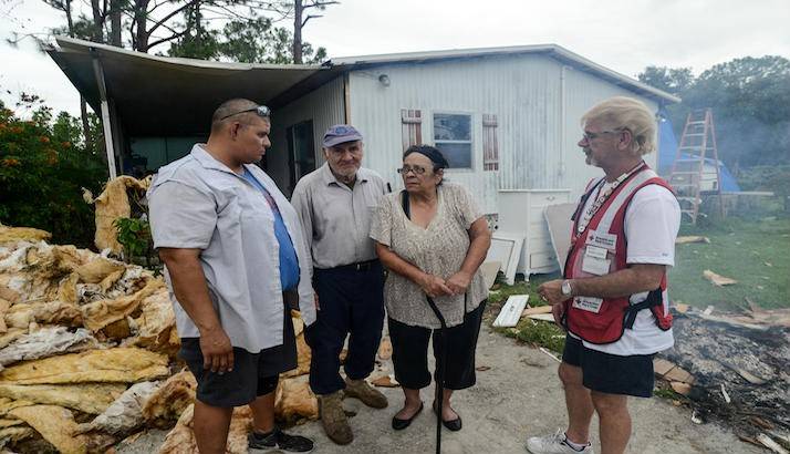 The Arroliga family talking with a Red Cross volunteer.