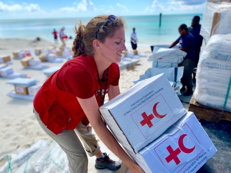 Red Cross worker Marine helps distribute emergency relief supplies to residents of Abaco, Bahamas.