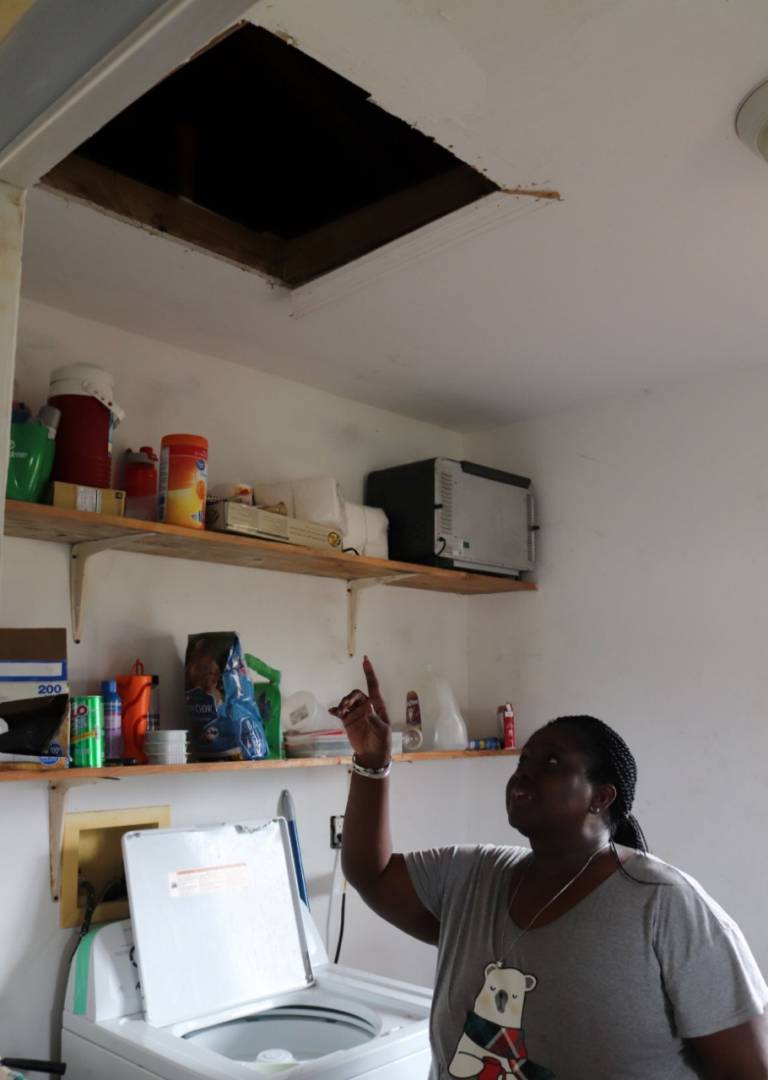 Linda Bowe points at the attic space where her family escaped the rising water as Hurricane Dorian thrashed overhead.