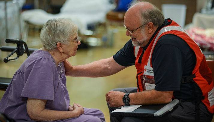 American Red Cross volunteer Bob Wallace chats with Virginia Marciniak, a shelter resident at the St Cloud Senior Center.
