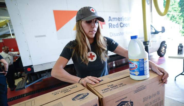 Red Cross volunteers at a Fayetteville Warehouse loading up supplies into trucks.