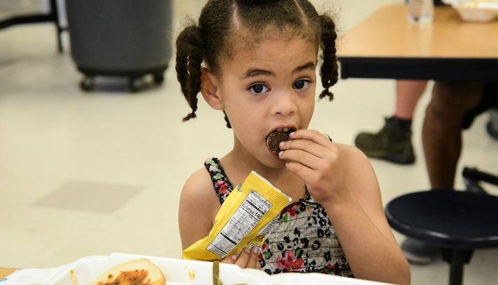 Five-year-old Alejah enjoys her meal while living in the shelter. 