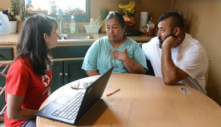 Virginia Rosales and Pedro Perez share their story with a Red Cross volunteer in Immokalee, Florida.