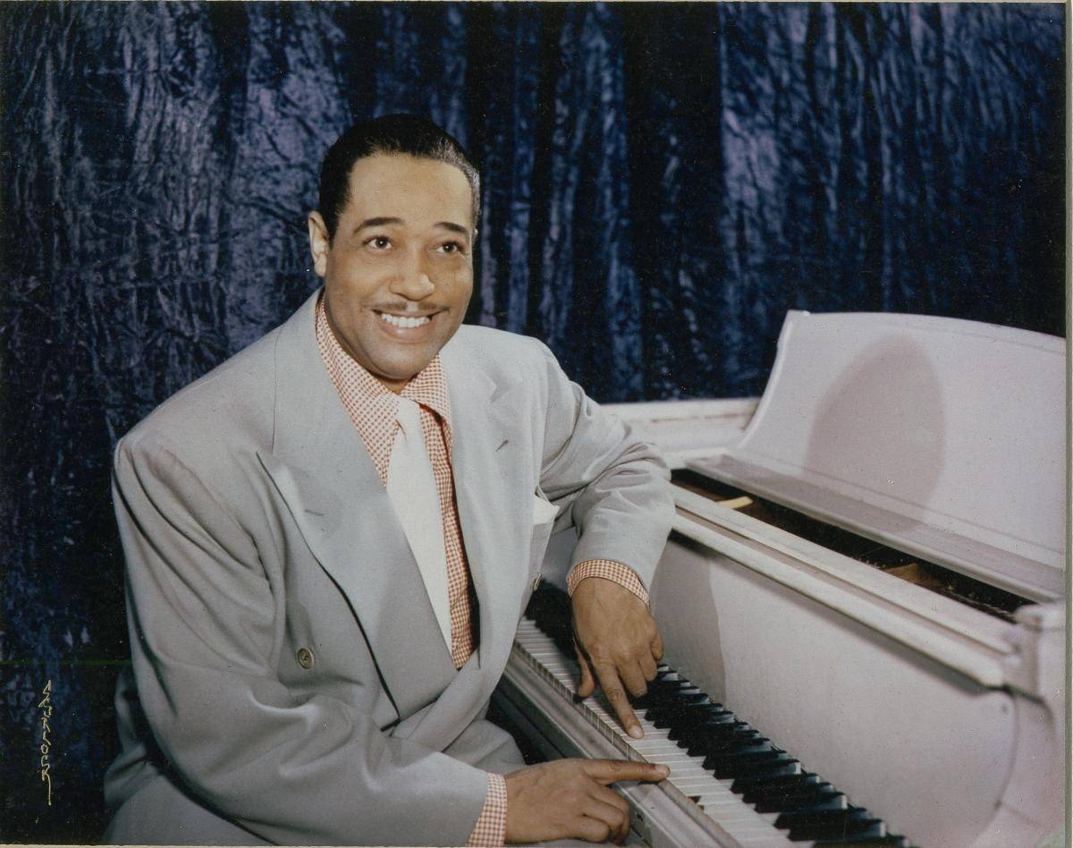 Duke Ellington sitting at his piano
