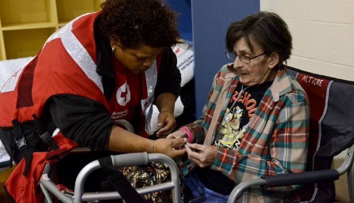 A Red Cross volunteer gives comforting words to Gertrude.