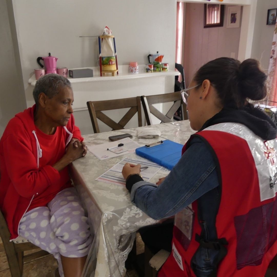 volunteer speaking with resident in home