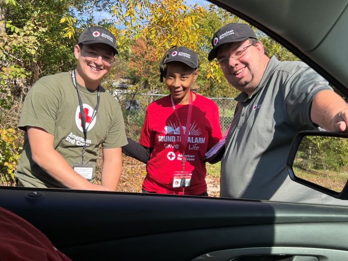 three red cross volunteers smiling