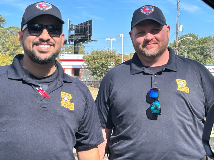 two fire fighters smiling 