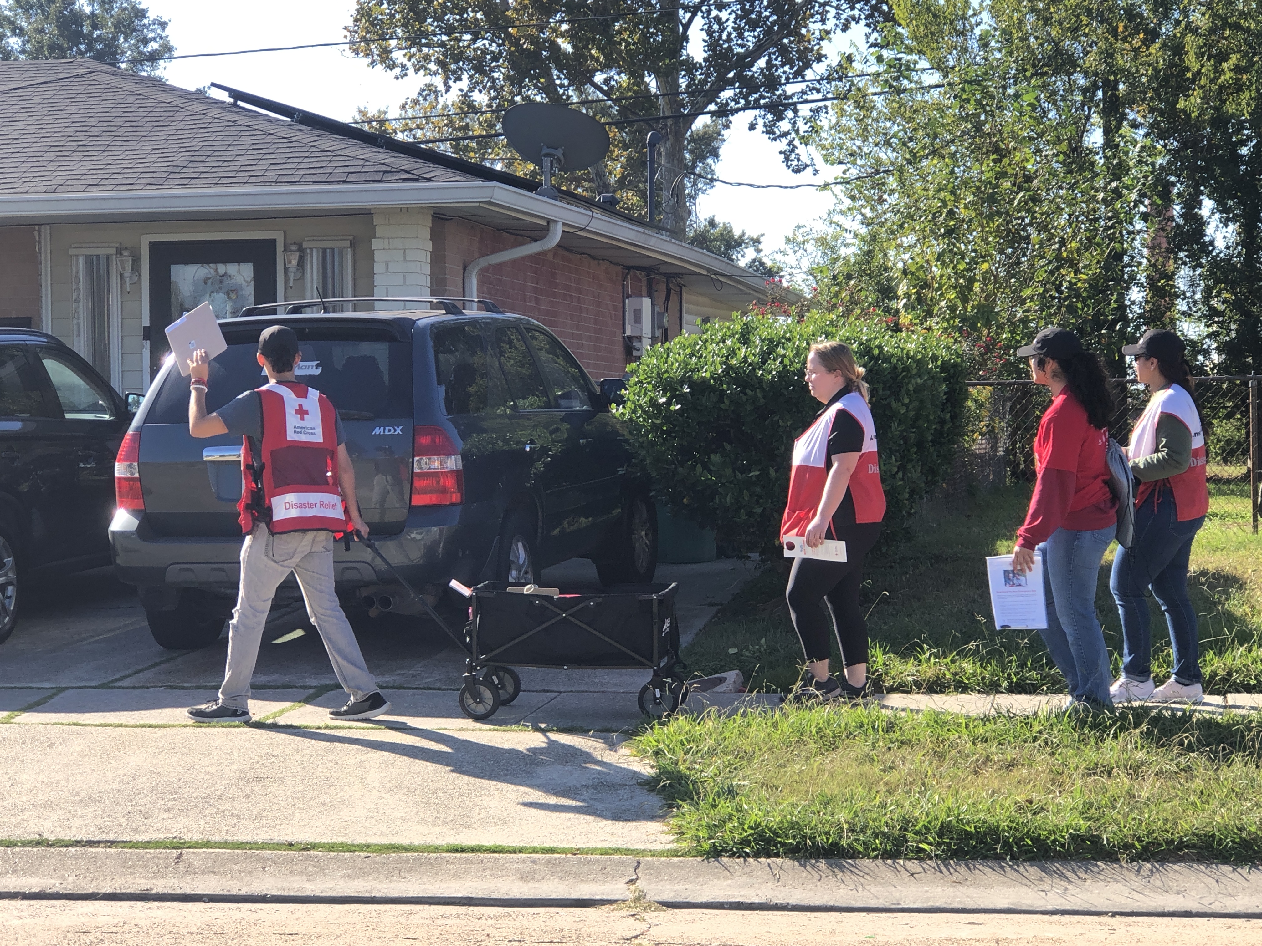 red cross volunteers walking in neighborhood