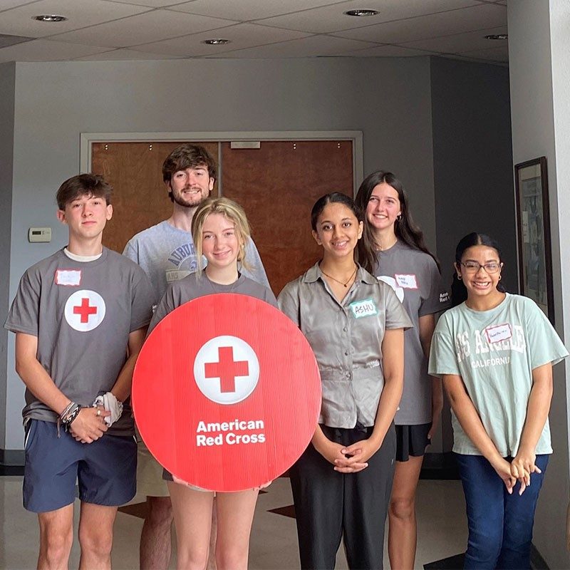 Group photo of youth leaders holding American Red Cross logo.