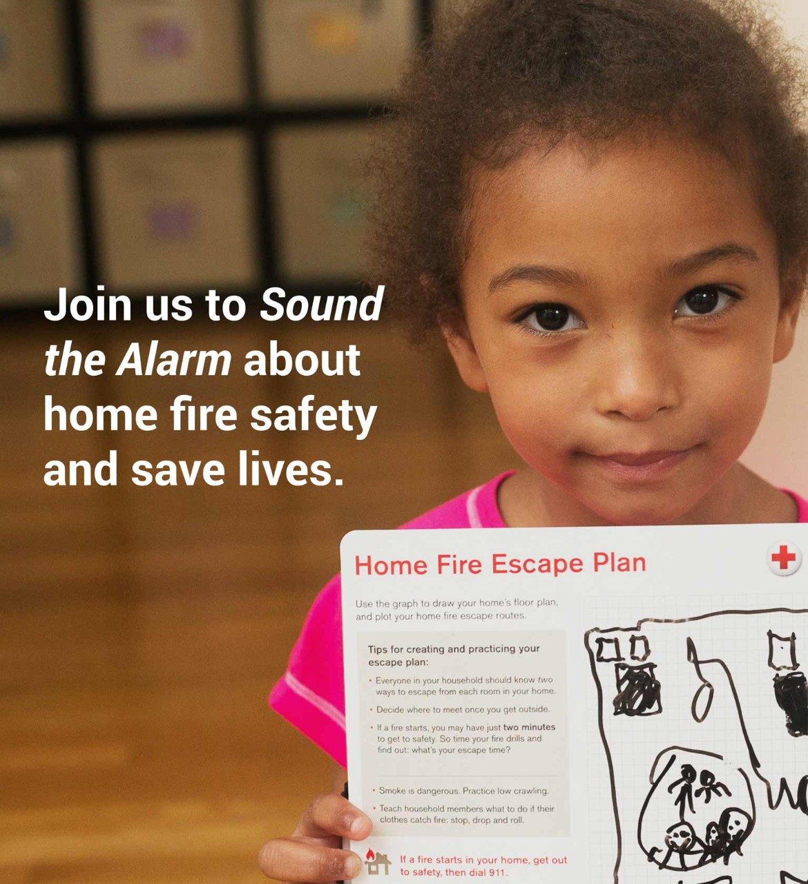 Little girl holding Home Fire Escape Plan looking at camera